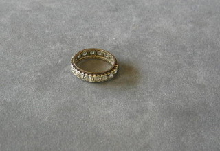 A lady's gold eternity ring set white stones