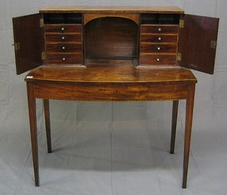 A Georgian inlaid mahogany writing table with raised super structure to the back, the interior fitted pigeon holes and 8 drawers with turned ivory handles, raised on square tapering supports 39"