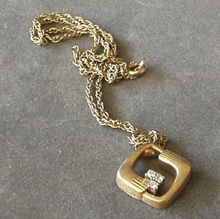 A fine gold chain hung a 9ct gold pendant set 3 diamonds