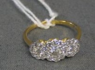 A lady's cluster dress ring set 3 diamonds surrounded by numerous diamonds (approx 0.60ct)