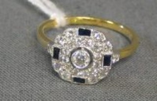A lady's gold dress ring set a circular diamond to the centre and 3 baguette cut sapphires supported by numerous diamonds 