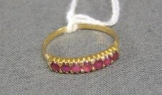 A lady's gold dress ring set pink coloured stones