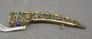 An Oriental silver gilt brooch in the form of a mandarins nail guard