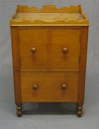 A 19th Century honey oak commode with wavy border fitted a double cupboard and 1 long drawer, raised on bun supports