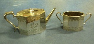 A 19th Century octagonal silver plated teapot and matching twin handled sugar bowl with engraved decoration