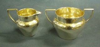 A plain silver twin handled sugar bowl and matching cream jug Sheffield 1910, 6 ozs