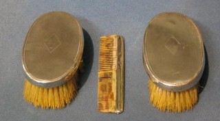 A pair of oval military hair brushes and a comb