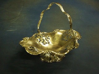 An oval pierced silver plated cake basket with swing handle, raised on a shaped base