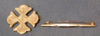 A silver cross shaped brooch and a bar brooch
