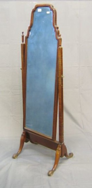 A 1930's Queen Anne style bevelled plate cheval mirror contained in a walnutwood swing frame