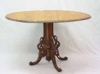 A 19th Century Continental pine oval drop flap pedestal occasional table, raised on a pierced turned column 24"