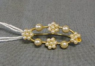 An Edwardian gold brooch set demi-pearls (1 missing)