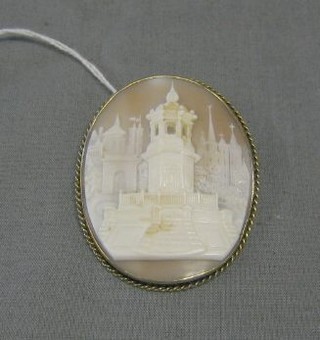 A 19th Century shell carved cameo brooch decorated a temple with spires in distance 3" contained in a gilt mount