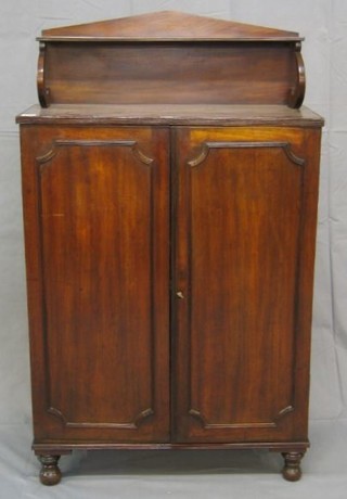A Regency mahogany chiffonier with raised shelved back, the interior fitted a shelf enclosed by panelled doors, raised on turned supports 28"
