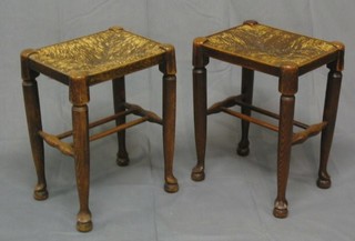 A pair of elm stools with woven rush seats on club supports united by an H framed stretcher