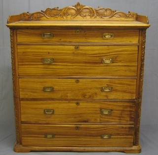 A 19th Century carved camphor wood military secretaire chest with carved three-quarter gallery above 1 long drawer and with well fitted secretaire drawer above 3 long drawers, with carved decoration to the corners, 45"
