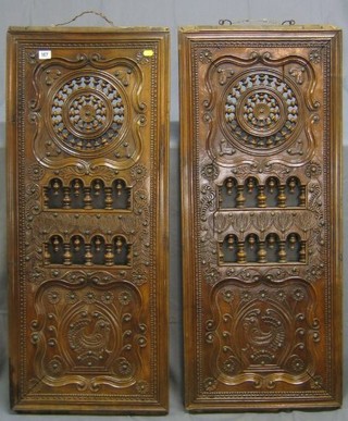 A pair of Continental pierced and carved walnutwood panels 43" x 18"