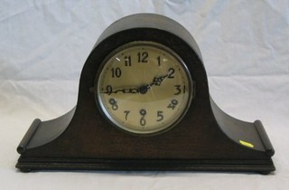 A 1930's 8 day chiming mantel clock with silvered dial and Arabic numerals contained in an oak case
