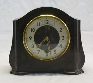 A 1930's 8 day mantel clock with silvered chapter ring and Arabic numerals in an arched brown Bakelite case by Smith Enfield