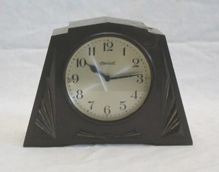 An Art Deco mantel clock with silvered dial and Arabic numerals in a Bakelite case by Ingersoll (f and r)