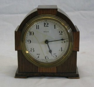 A French 8 day bedroom timepiece with enamelled dial, crazed and cracked contained in an oak arched case