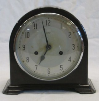 A 1930's 8 day chiming mantel clock with silvered dial, Arabic numerals contained in a brown Bakelite case