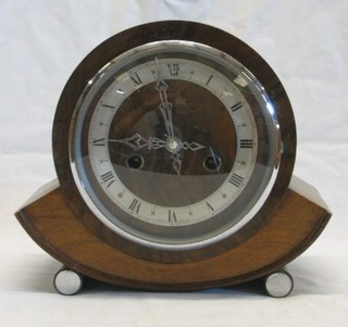 A 1930's 8 day striking mantel clock contained in a circular walnutwood case