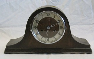 A 1930's 8 day striking mantel clock in an oak "Admirals hat" case