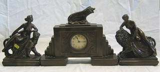 A plaster clock garniture incorporating a Continental timepiece with circular paper dial and Arabic numerals contained in a plaster case surmounted by a figure of a roaring lion and 2 side pieces decorated 2 ladies sat upon a lion and lioness