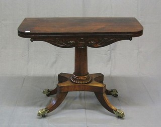 A William IV carved rosewood card table, raised on a gun barrel turned column with triform base, raised on splayed feet ending in brass caps and castors 36"