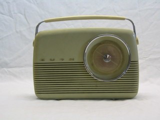 A Bush type TR82C portable radio in a green plastic case