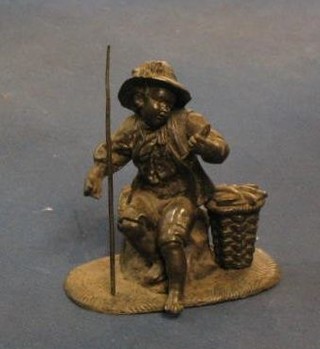 A spelter figure of a seated fisherman 