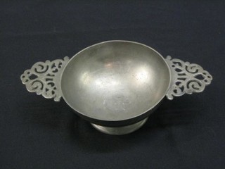 A pewter twin handled quaiche, the base marked with winged cherub and monogrammed IVM 9"