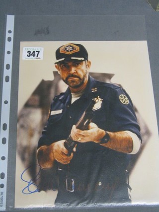 A  colour photograph of Sean Connery wearing an American Police Uniform from the film Outland, signed Sean Connery