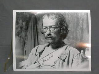 A signed black and white photograph of John Hurt