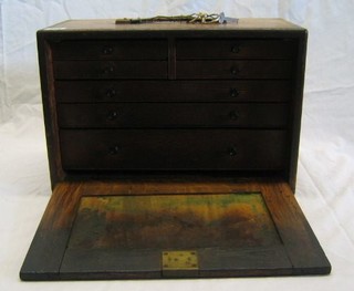 An oak tool maker's chest containing 6 pairs of callipers, 2 protractors, numerous rules