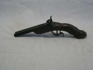 A reproduction double barrelled percussion lock pistol