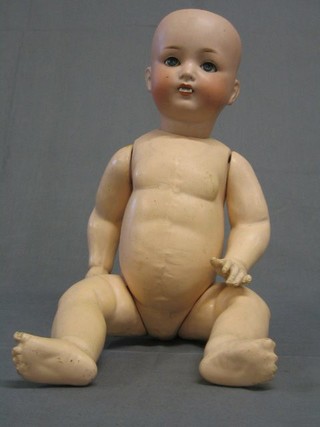 A German porcelain headed doll with open and shutting eyes, open mouth, marked PM 23 Germany