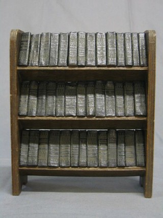 A miniature set of The Complete Works of Shakespeare by Allied Newspapers, contained in an oak 3 tier book trough
