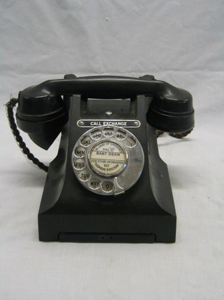 An old black Bakelite dial telephone