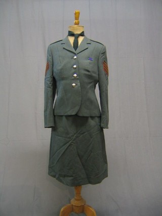 A  Sargent's Wrac Lovet green service dress jacket and skirt with Royal Corps of Signals buttons and a Lance Corporal's rain coat