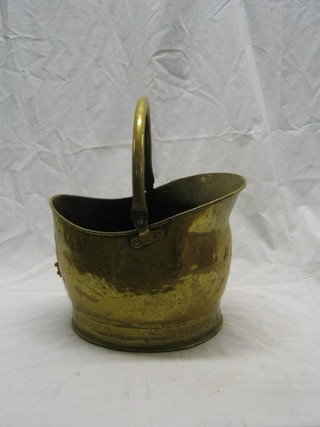 A brass helmet shaped coal scuttle