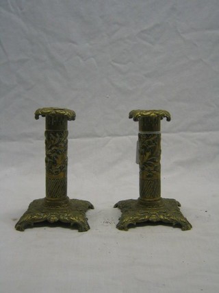 A pair of embossed brass candlesticks 7"
