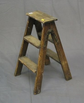 A pair of 4 tread pine folding platform steps