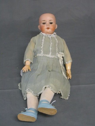 An Armand Marseille porcelain headed doll with open and shutting eyes, open mouth, the head incised Armand Marseille Germany 390 A 1/2 M, with articulated body