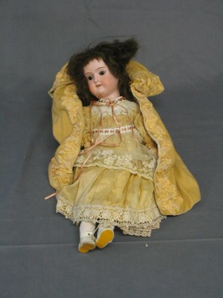 A 19th Century German biscuit porcelain headed doll with open and shutting eyes and open mouth, the head incised Made in Germany 890 EM 2/0X