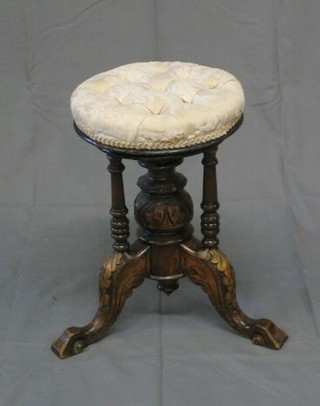 A Victorian oak revolving adjustable piano stool raised on bulbous carved turned column