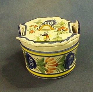 A circular Quimper butter dish and cover, the lid decorated a standing lady, the base marked HB Quimper 298 2, 4"