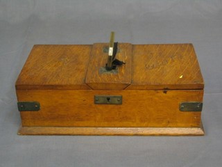 An Edwardian oak twin section brass banded cigar box with hinged lid 13"