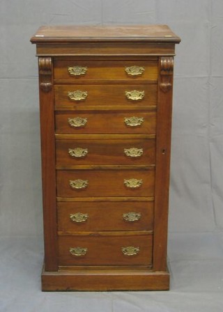 A Victorian walnutwood Wellington chest of 7 drawers and pierced brass swan  neck drop handles 24"